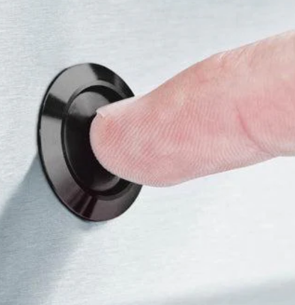 Close-up of finger pressing control button on Broil King CROWN 520 with professional-grade performance