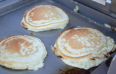 Kokomo BBQ Grill Griddle plate insert cooking pancakes on stainless steel surface