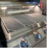 LuxCut Laser Cut Culinary Grates made of 304 stainless steel on a multi-burner grill for precise heat distribution and durability.