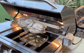 KoKoMo BBQ grill rotisserie kit with motor and stainless steel spit rod roasting whole chickens on gas grill